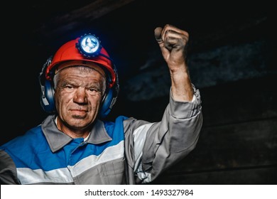 Miner man hands protest fist up revolution coal mine. Concept workers strike.