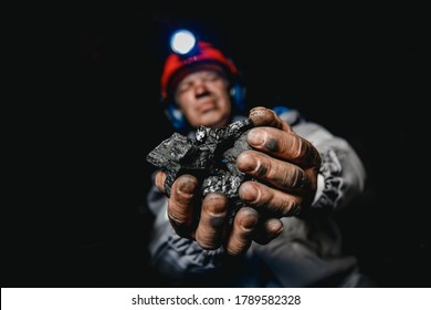 Miner Man Worker Holds Coal Palm. Concept Mining.