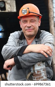 Miner In A Mine. Worker With Coal At Open Pit