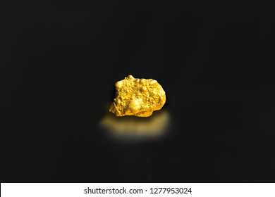 Miner Of Raw Gold Nugget Or Gold Ore On Black Background, Advertisement Precious Stone Or Lump Of Golden Stone, Business And Financial Concept Idea. Closeup Gold Miner Industry Concept.