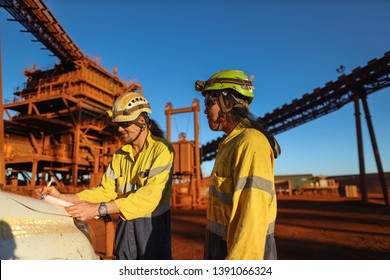 Miner Supervisor Engineer Wearing Safety Fall Protection Helmet Read And Sign Permit To Work Before Hand Over Working At Height Paper Book To Contractor Construction Mine Site, Sydney, Australia  