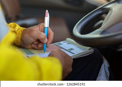 Miner Track Driver Hand Writing Checking Faulty, Defective, Damage Inspecting On The Truck Prior To Drive On Construction Mine Site, Perth, Australia 