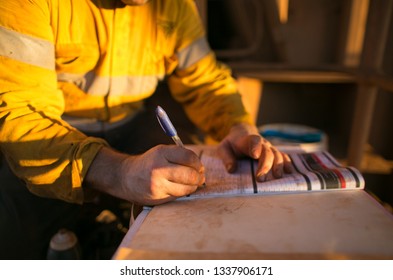 Miner Worker Hand Signing Safety Risk Assessment JHA Paper Permit To Work Prior Performing High Risk Task At Construction Mine Site Perth, Australia    