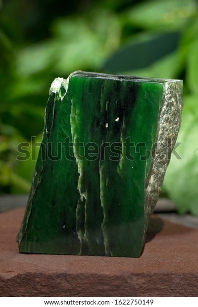 Mineral\
jade on a vegetable background. Green\
gemstones.