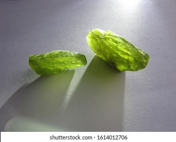 mineral natural rough Peridot gemstone crystal with the light background