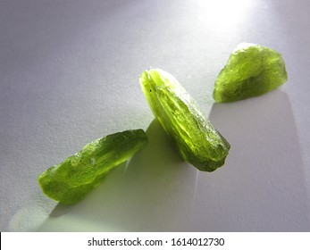 mineral natural rough Peridot gemstone crystal with the light background