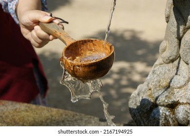 Mineral Water Is Dripped With A Wooden Ladle.