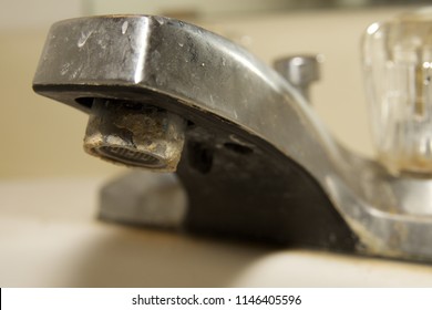 Minerals from hard water on bathroom sink faucet.