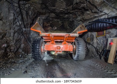 Minetruck dump haul truck in underground gold mine shaft tunnel