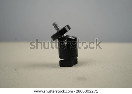 A mini ball head is a compact mounting head for cameras, smartphones, or accessories (such as microphones and lights) that utilizes a ball mechanism for 360-degree rotation. Typically equipped with a 1 per 4-inch screw, this device is highly portable and allows for quick angle locking using a single twist knob.