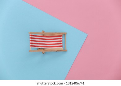 Mini Beach Chair On A Blue-pink Pastel Background. Top View