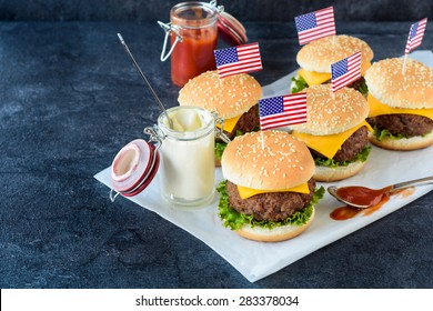 Mini beef cheeseburgers with American flags on top,selective focus  - Powered by Shutterstock