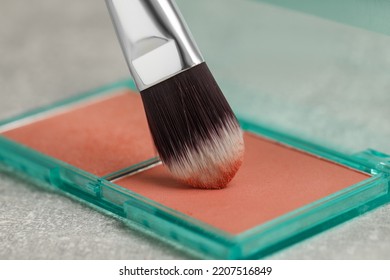 Mini Blush Palette With Brush On Grey Table, Closeup