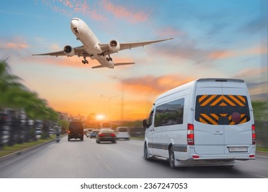 Mini bus drives along the highway among other cars in the evening in the sunset sky, a passenger jet airliner plane flies sky. - Shutterstock ID 2367247053