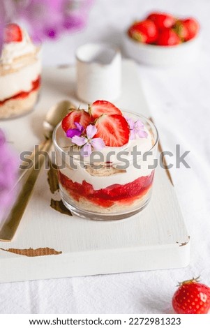 Mini cakes with fresh berries and vanilla cream in a glass. Individual cakes. 