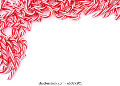 Mini candy canes making a border on a white background, Christmas Candy cane