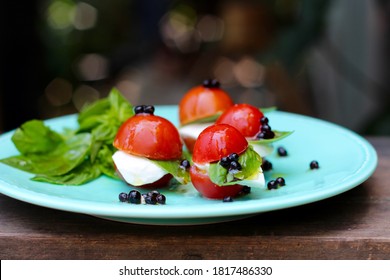 Mini Caprese Salad Bites With Fresh Mozzarella Cheese, Cherry Tomatoes, Italian Basil, And Balsamic Pearls.