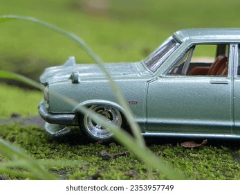 mini car figure blues series original on a green mossy floor . classic custom. mobile auto at the natural background  - Powered by Shutterstock