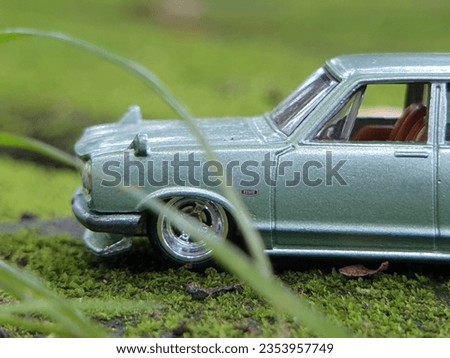 mini car figure blues series original on a green mossy floor . classic custom. mobile auto at the natural background 
