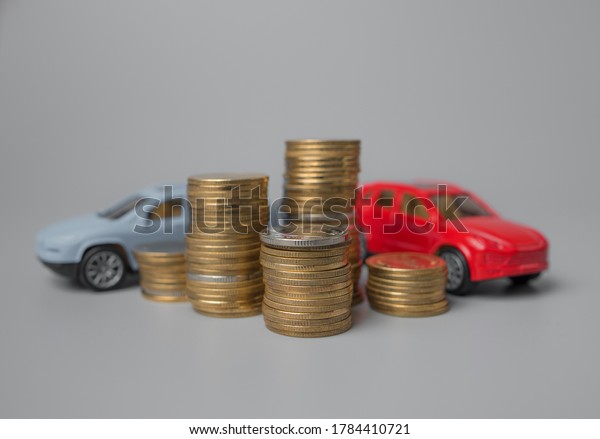 Mini car model with stack of golden\
coins,saving for car,loan and financial\
concept