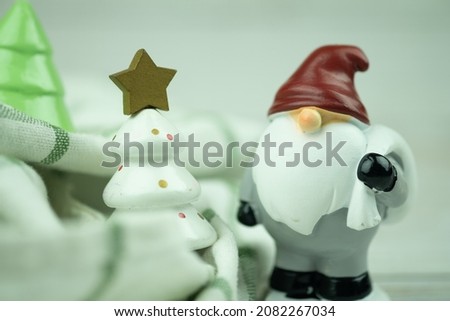 Mini ceramic santa claus doll and Christmas tree for decorate in festival for design. Selective focus