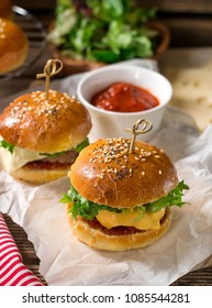 Mini Cheeseburgers Sliders With Ground Beef, Cheddar, Lettuce, Onions And Tomato Sauce