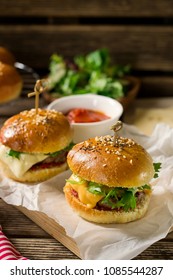 Mini Cheeseburgers Sliders With Ground Beef, Cheddar, Lettuce, Onions And Tomato Sauce