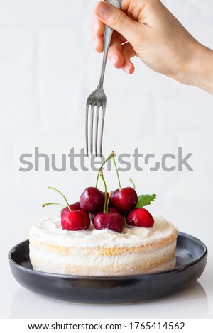 Mini Cherry Cake ready to eat with cherries and a hand with fork