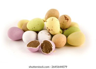Mini chocolate eggs with candy coating on a white background.