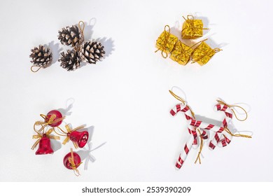 mini christmas decorations. gold gift box, christmas bells, candy nails, and pine cones. isolated on white. - Powered by Shutterstock