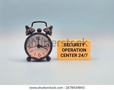 A mini clock and a note that says "SECURITY OPERATION CENTER 24 BY 7". This clear visual metaphor represents the continuous vigilance of an SOC in cybersecurity defense and risk management.