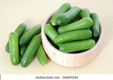 Mini Cucumbers In Wooden Bowl On Table