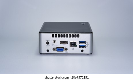 Mini Desktop Personal Computer With HDMI, VGA, 2 X USB 3.0, LAN, Audio Port, And 19 Volt DC Power Supply, Silver Plastic Case, White Background Isolated