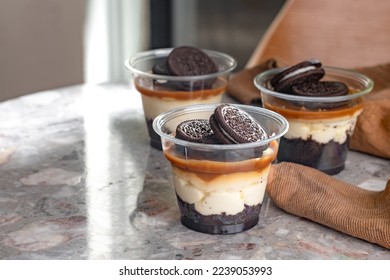 Mini desserts snacks in plastic cups. On the table Cheescake to go