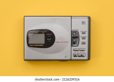 Mini Disc Player From The 1990's. Close Up View With Yellow Background.