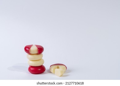 Mini Edam Ball Cheese Covered In Red Wax With White Background