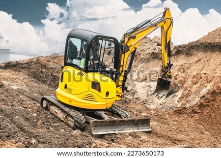 Mini excavator at the construction site. Compact construction equipment for earthworks. An indispensable assistant for earthworks. Rental of construction equipment