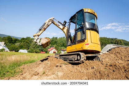 Mini Excavator Digging Preparing Ground Under Home Garden