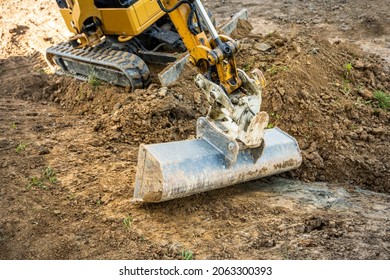 Mini Excavator Digging Preparing Ground Under Home Garden