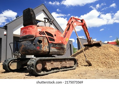 A Mini Excavator Prepared To Spread The Aggregate On The Construction Site.