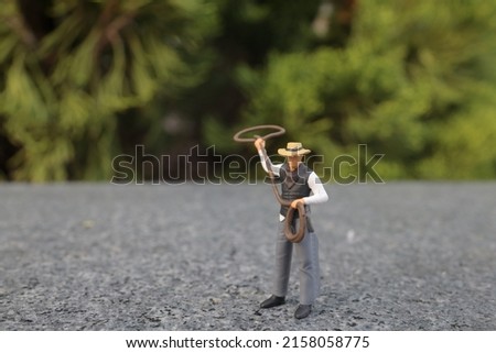 the mini figure cow boy galloping with lasso in hand