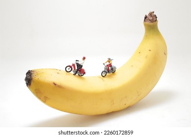 a mini figure of ride a motorbike on banana - Shutterstock ID 2260172859