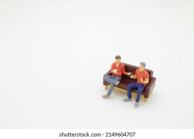 mini friends talking sitting in a couch in the living room