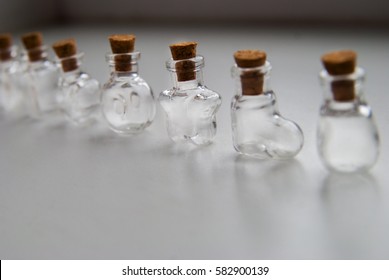 Mini Glass bottles different forms with cork stopper on white background