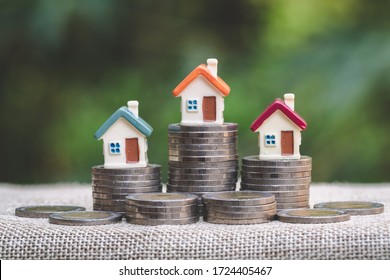 Mini house on stack of coins, Concept of Investment property, Investment risk and uncertainty in the real estate housing market. - Shutterstock ID 1724405467