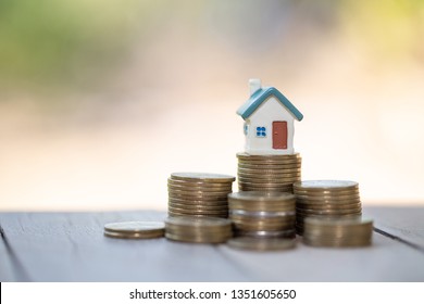 Mini house on stack of coins,Money and house,  Mortgage, Savings money for buy house and loan to business investment for real estate concept. Invesment and Risk Management.