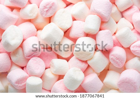 Mini marshmallows of white and light pink colors. Selective Focus. Flat lay.