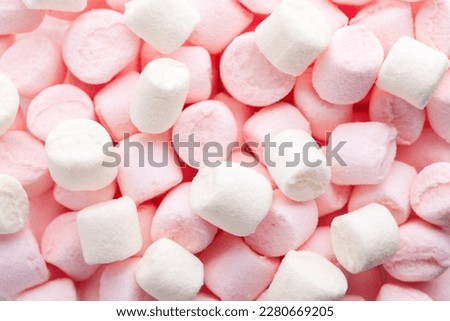 Mini marshmallows of white and light pink colors. Selective Focus. Flat lay.