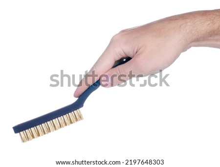 Mini metal brush in hand on white background isolation
