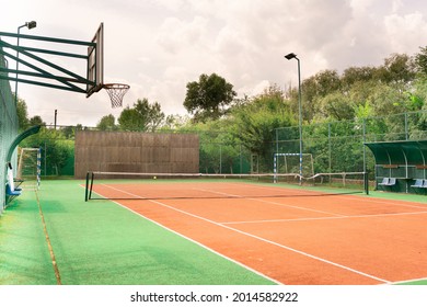 Mini outdoor sports ground, facilities for training and playing football, basketball, volleyball and tennis court. Active recreation in the park on a summer day surrounded by trees